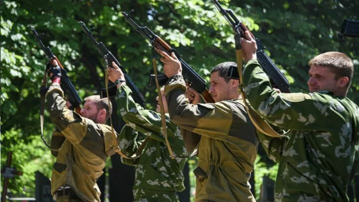 Proruští povstalci střílejí do vzduchu na pohřbu svého spolubojovníka zabitého v bitvě o Marinku u Doněcka. Rok 2015.