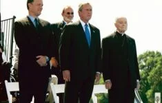 Herec Tom Hanks, prezident George W. Bush a arcibiskup Philip M. Hannan při ceremoniálu na paměť skončení druhé světové války (Washington, 29. 5. 2004)