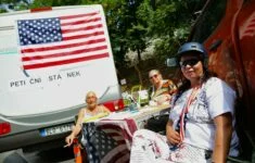 Karavan, osobní auto, stolek, židličky, archy s peticemi, vlajky Spojených států a NATO. Tohle všechno se ve středu 21. června objevilo u chodníku naproti sídlu české vlády. 