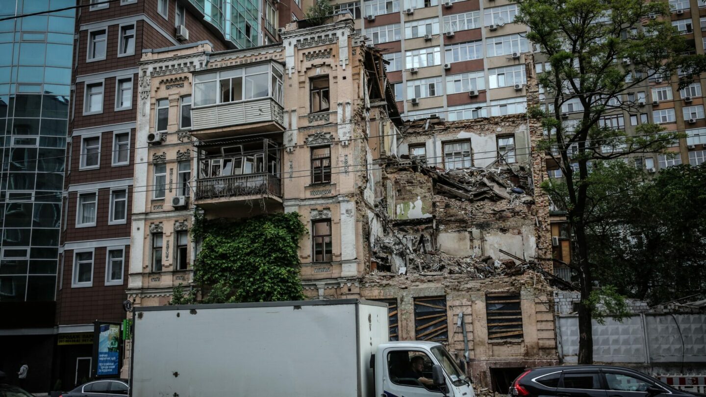 Ruská raketa strhla střechu a roh domu. Dírou jde ještě vidět vybavení bytů, ve kterých před válkou žili lidé.
